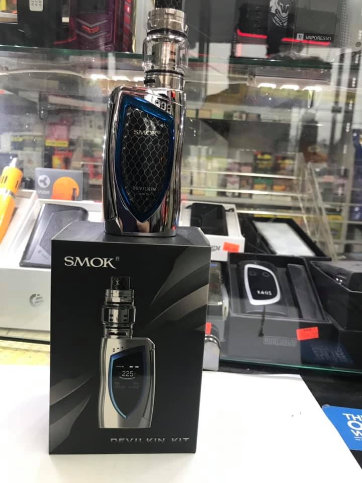 Metallic SMOK vape device with blue and black detailing, displayed on its matching product box in a Columbia Vape shop store.